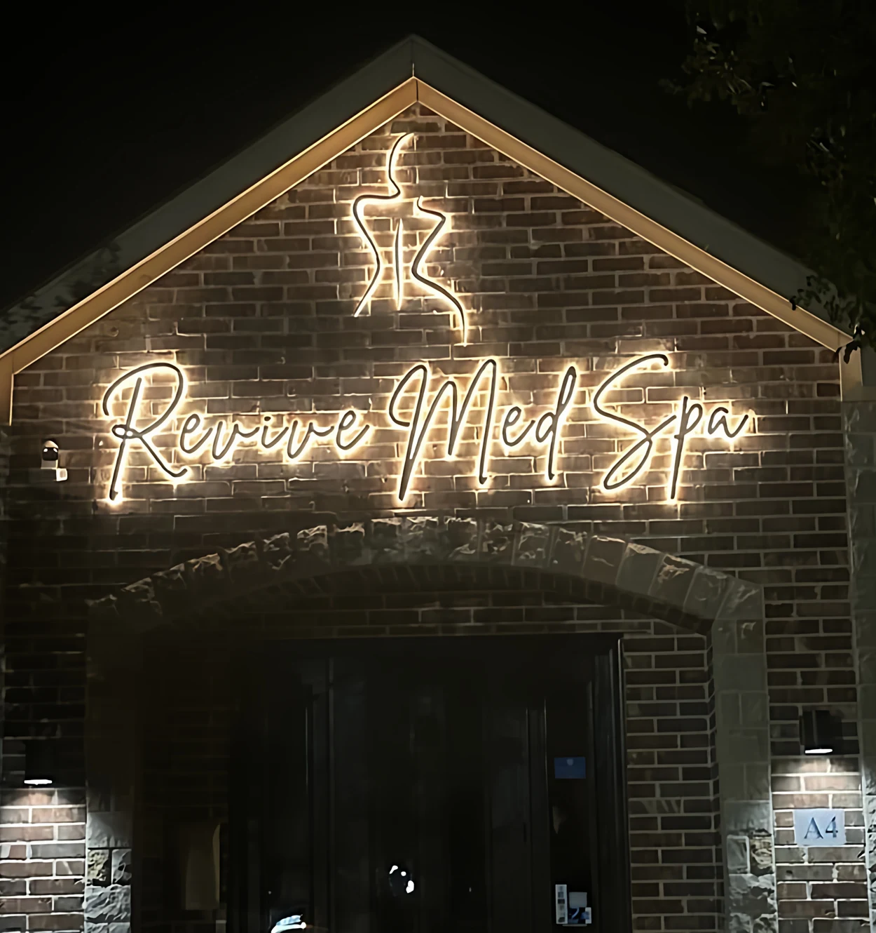 Modern stainless steel and acrylic LED signage with bright illumination